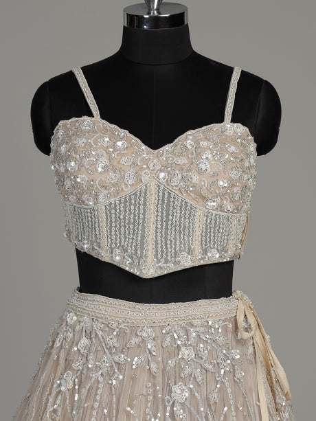 Beige net designer lehenga choli with heavy embellished cape shrug