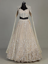 Beige net designer lehenga choli with heavy embellished cape shrug