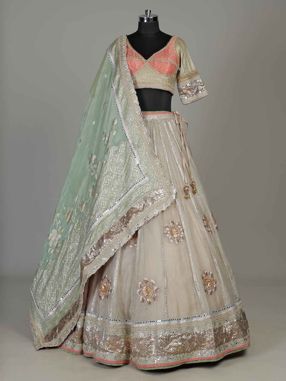 Pastel beige tissue lehenga choli with contrast dupatta embellishments