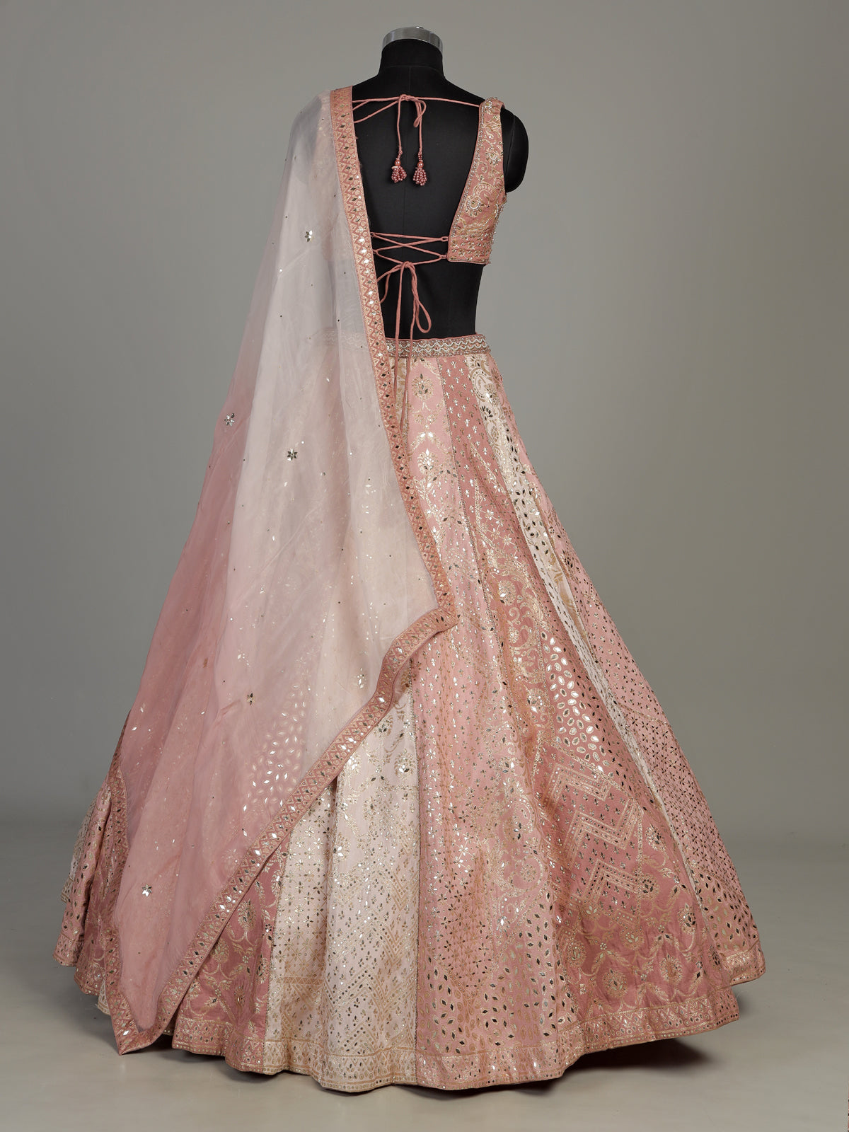 Peach silk lehenga choli with exquisite mirror zari embellishments