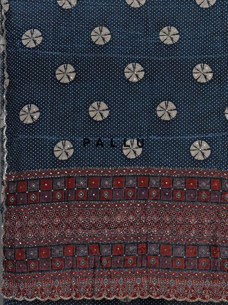 Blue crepe silk saree with printed patterns and traditional aabla work