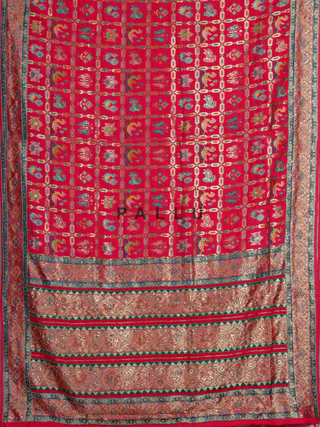 Deep rani pink modal satin saree with colourful motifs and embellishments