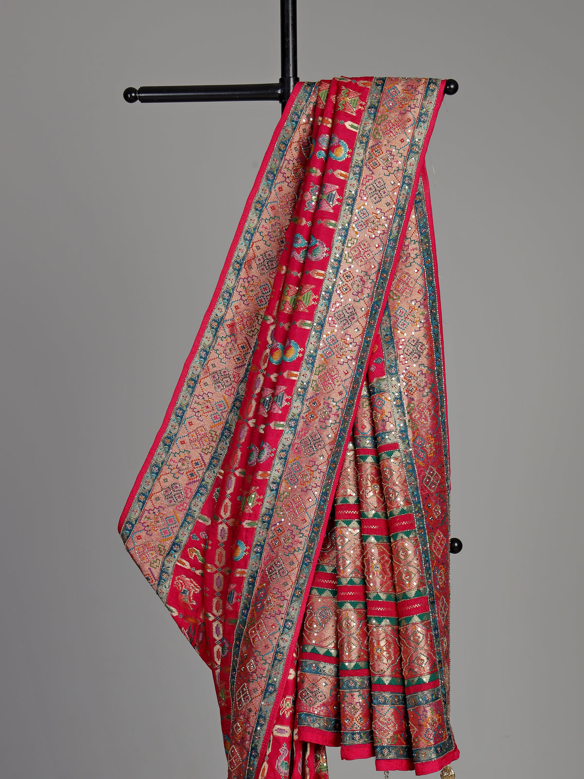 Deep rani pink modal satin saree with colourful motifs and embellishments