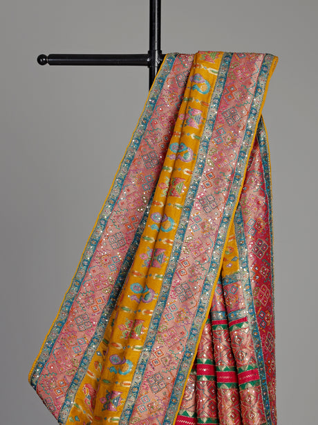 Mustard yellow modal satin saree with colourful motifs and tassel detailing