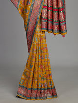 Mustard yellow modal satin saree with colourful motifs and tassel detailing