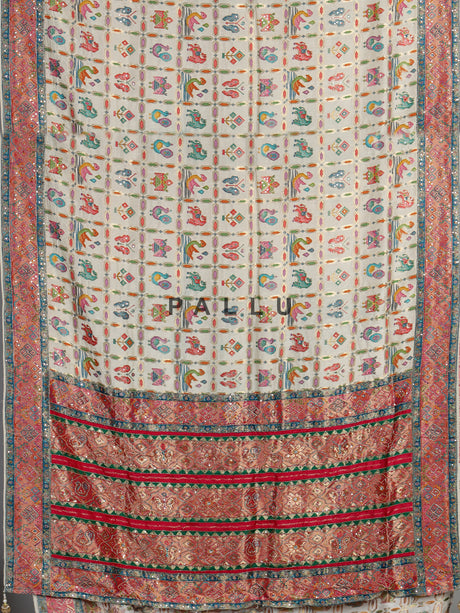 Cream modal satin saree with colourful motifs and intricate zari embellishments