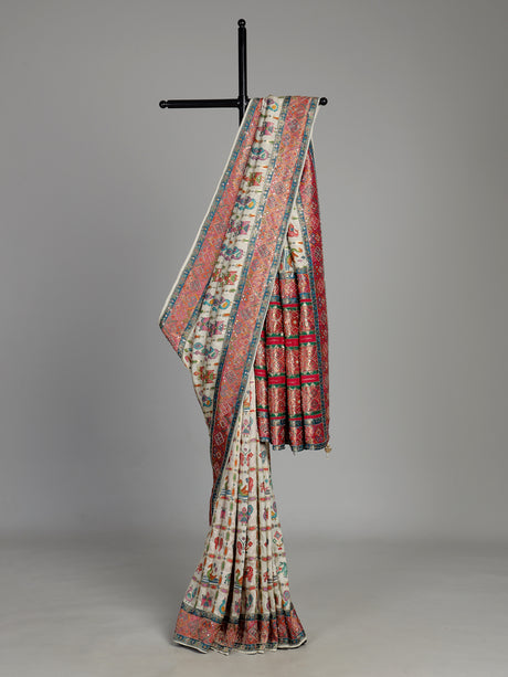 Cream modal satin saree with colourful motifs and intricate zari embellishments