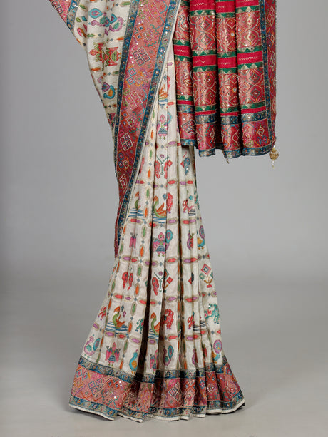 Cream modal satin saree with colourful motifs and intricate zari embellishments
