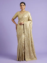 Pastel cream tissue silk saree with intricate festive embellishments and zari