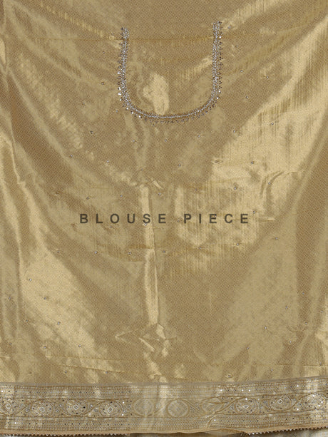 Pastel cream tissue silk saree with intricate festive embellishments and zari