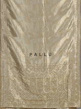 Pastel cream tissue silk saree with intricate festive embellishments and zari