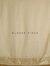 Cream tissue silk saree with mirror accents and intricate festive embroidery