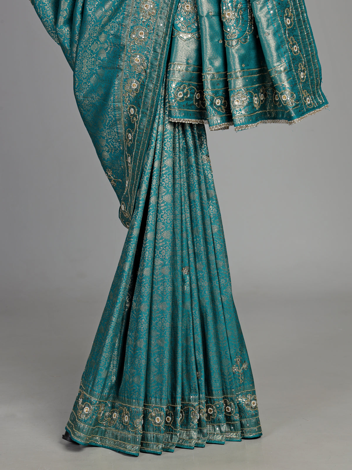 Aqua kanjivaram silk saree with ornate mirror work and zari accents