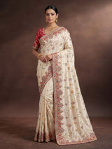 Cream pojisan silk saree with floral motifs and ornate zardosi embroidery