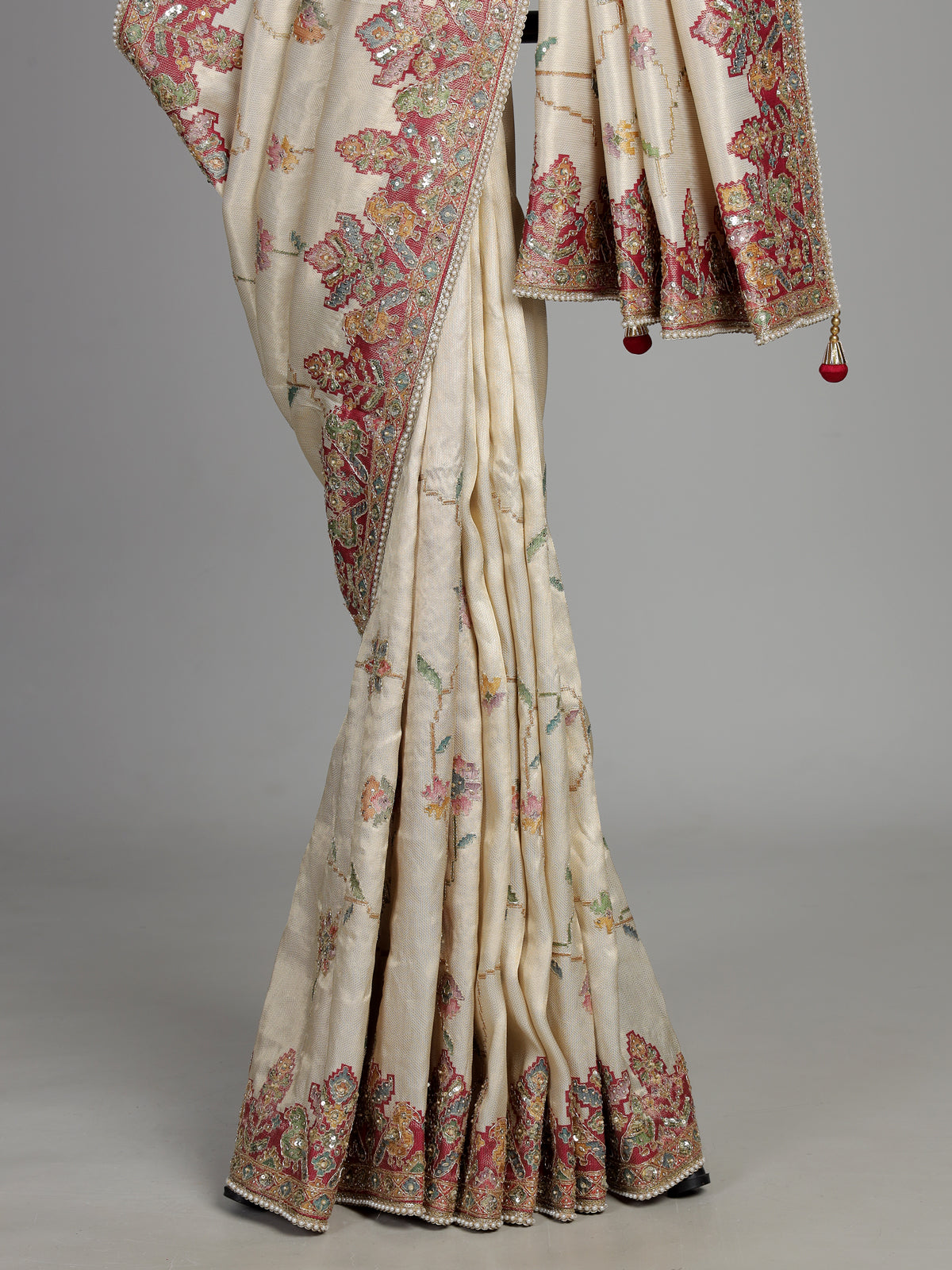 Cream pojisan silk saree with floral motifs and ornate zardosi embroidery