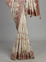 Cream pojisan silk saree with floral motifs and ornate zardosi embroidery