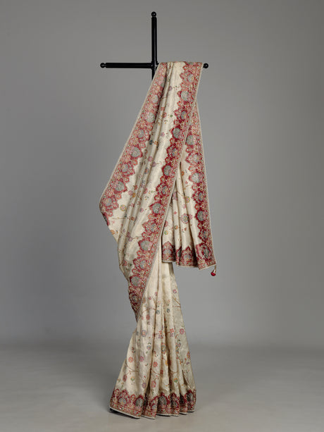 Cream pashmina saree with floral motifs and contrasting embellished border