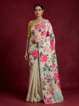 Cream crepe silk saree with checked patterns and floral embellishments