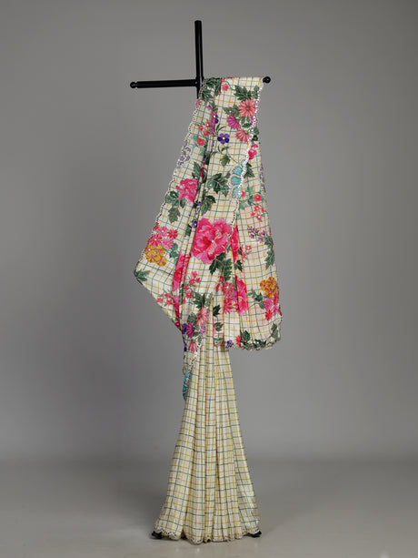 Cream crepe silk saree with checked patterns and floral embellishments