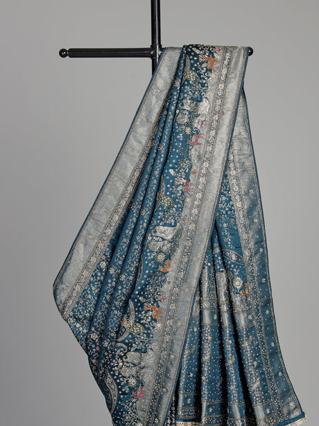 Teal blue semi silk saree with artistic animal and bird motifs