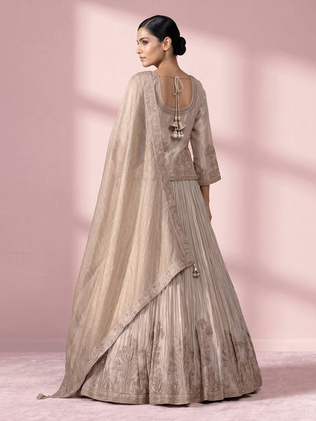 Pastel beige tissue silk lehenga choli with intricate zardosi detailing
