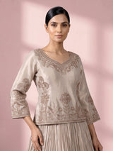 Pastel beige tissue silk lehenga choli with intricate zardosi detailing