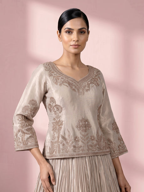 Pastel beige tissue silk lehenga choli with intricate zardosi detailing