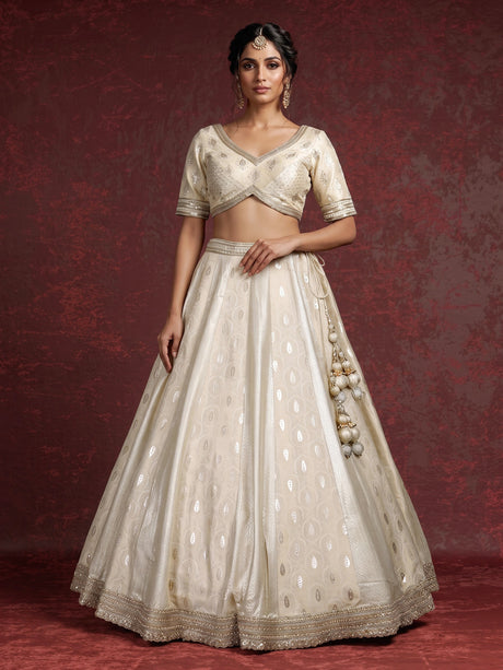 Cream banarasi silk lehenga choli with intricate zardosi embellishments