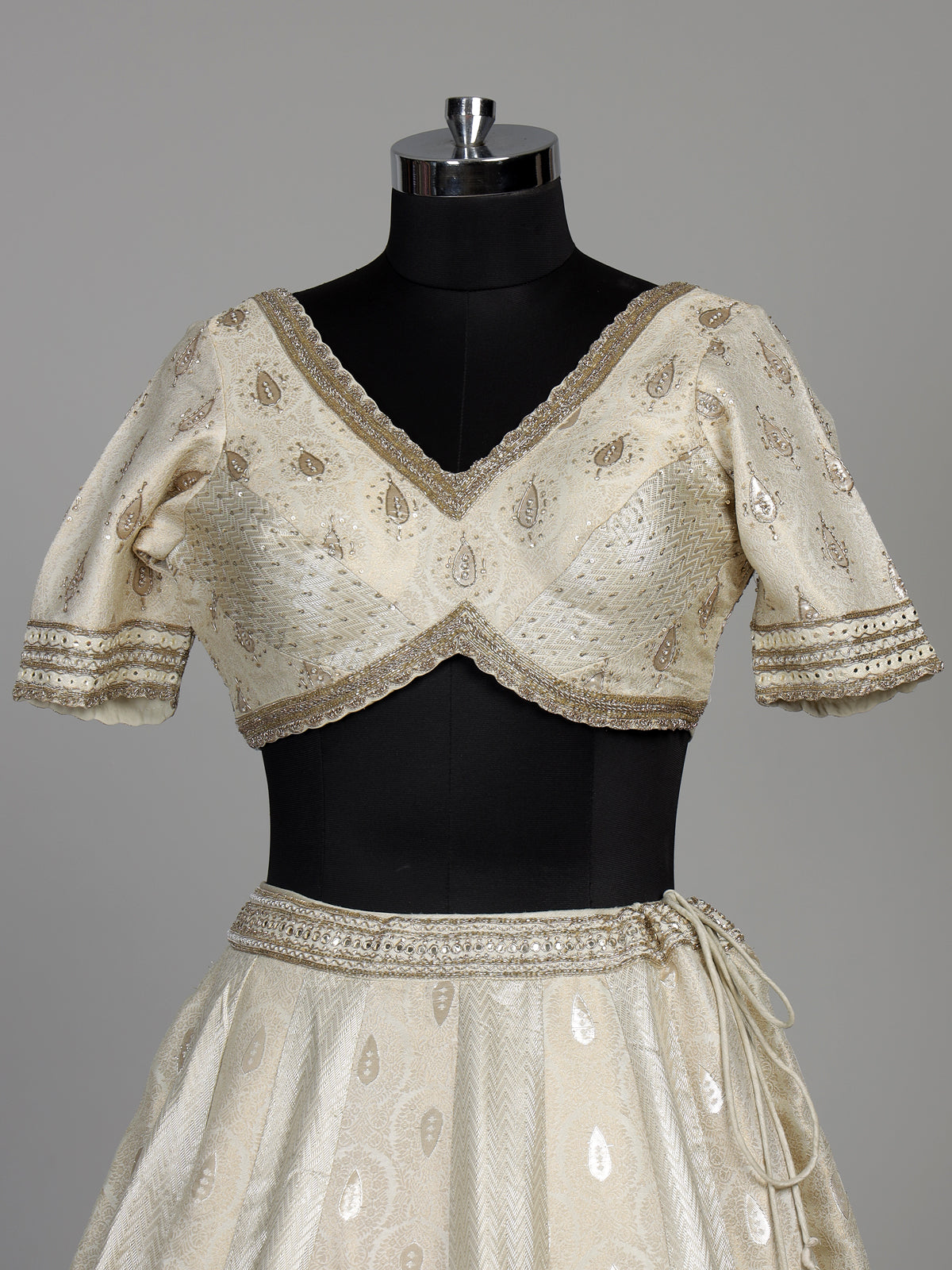 Cream banarasi silk lehenga choli with intricate zardosi embellishments