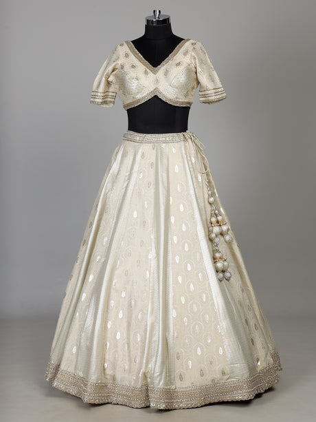 Cream banarasi silk lehenga choli with intricate zardosi embellishments