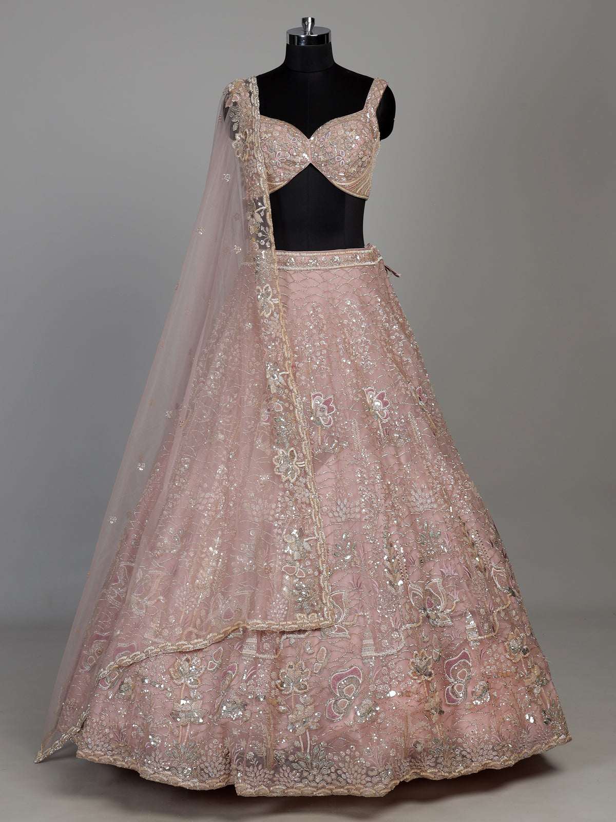 Light pink net lehenga choli with cutdana and sequin embellishments