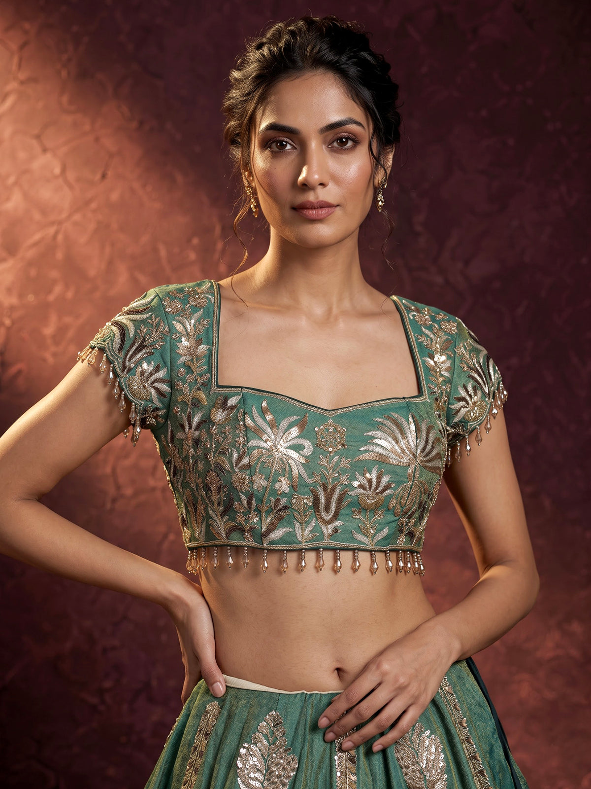Green silk lehenga choli with intricate zardosi and tassel detailing