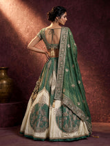 Green silk lehenga choli with intricate zardosi and tassel detailing