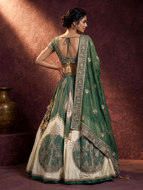 Green silk lehenga choli with intricate zardosi and tassel detailing