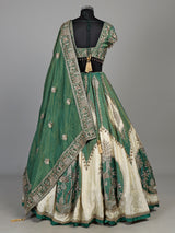 Green silk lehenga choli with intricate zardosi and tassel detailing