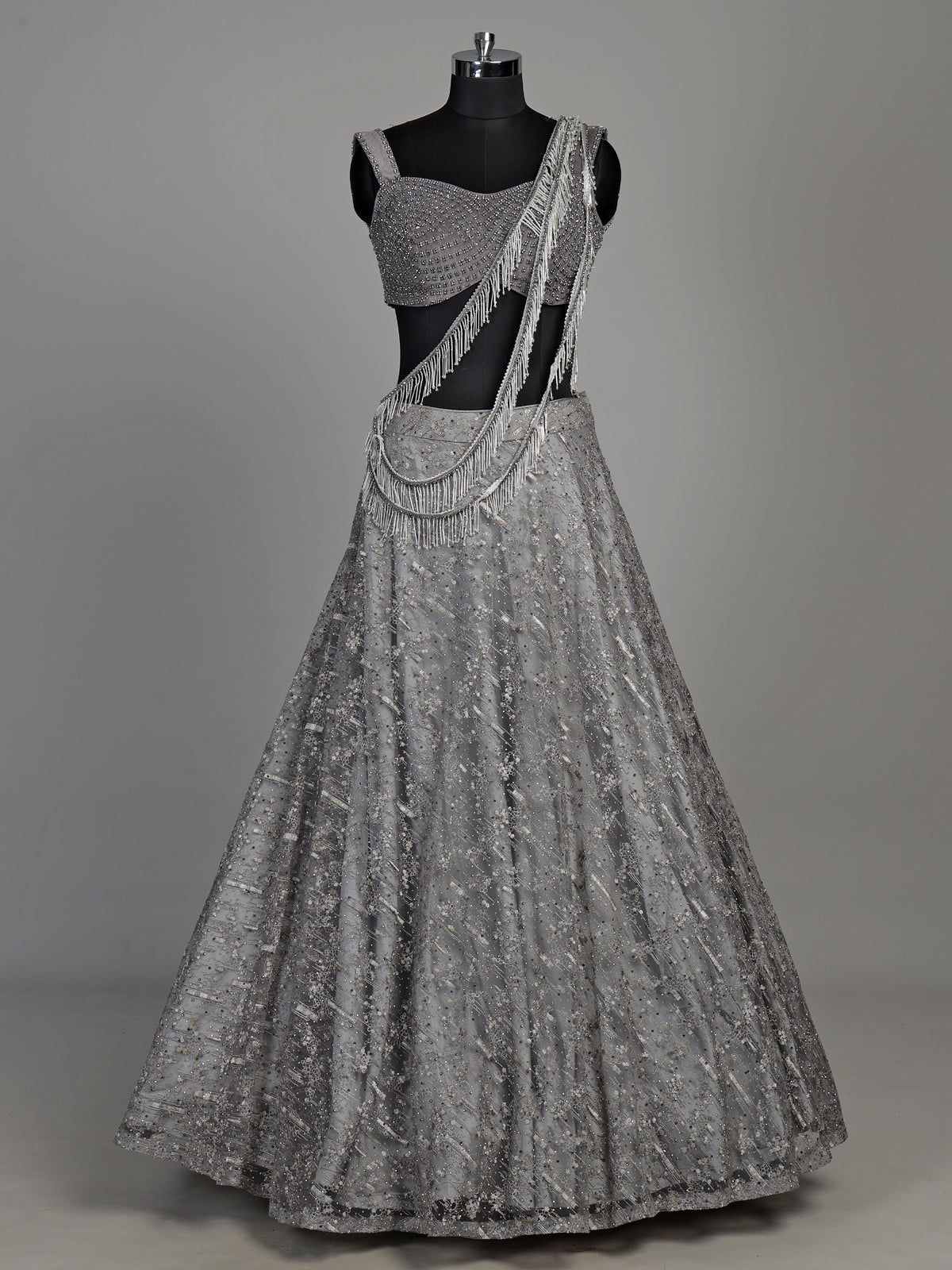 Grey net lehenga choli with pearl embellishments and designer detailing