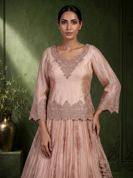 Pastel peach tissue silk lehenga choli with intricate cutdana embellishments