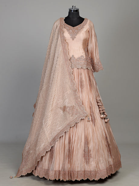 Pastel peach tissue silk lehenga choli with intricate cutdana embellishments