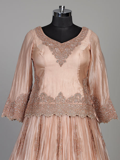 Pastel peach tissue silk lehenga choli with intricate cutdana embellishments