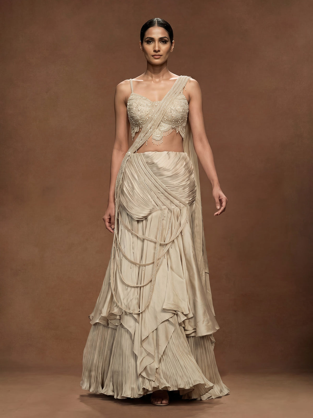Cream chiffon georgette lehenga choli with pearl and tassel embellishments