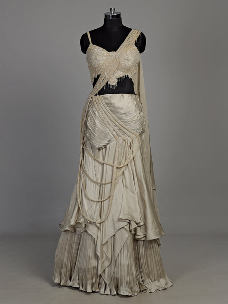 Cream chiffon georgette lehenga choli with pearl and tassel embellishments