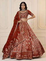 Rust orange silk lehenga choli with mirror and zardosi work
