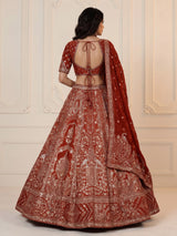 Rust orange silk lehenga choli with mirror and zardosi work