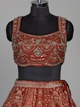 Rust orange silk lehenga choli with mirror and zardosi work