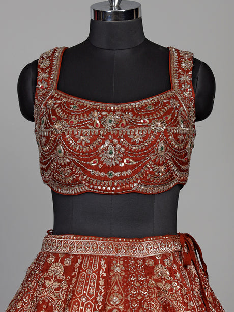 Rust orange silk lehenga choli with mirror and zardosi work