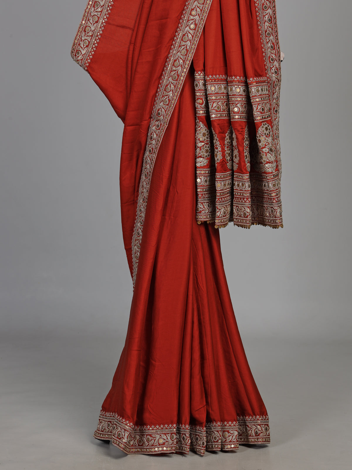 Elegant rust red silk saree with embroidered pallu and sequins