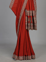 Elegant rust red silk saree with embroidered pallu and sequins