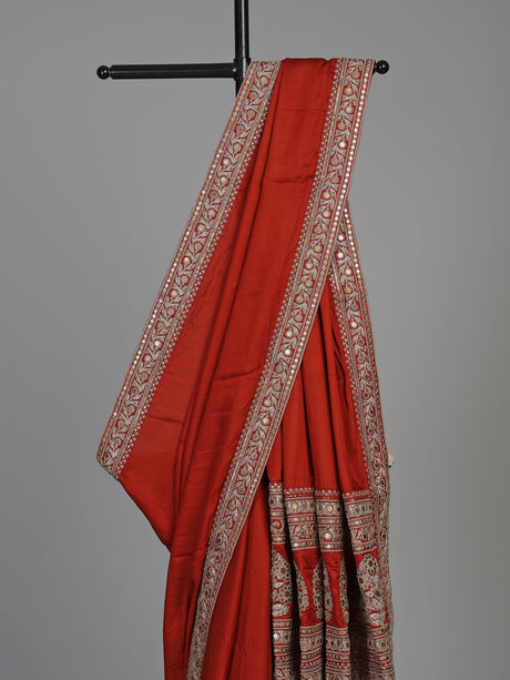 Elegant rust red silk saree with embroidered pallu and sequins