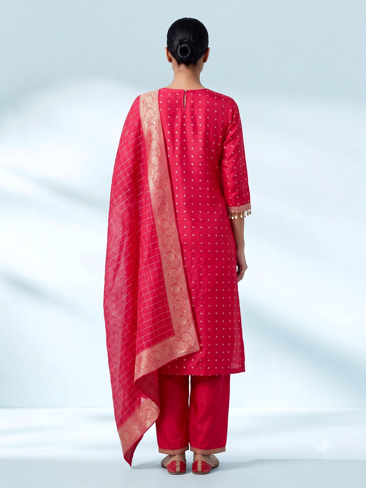 Rani pink silk bandhani suit with an embellished yoke