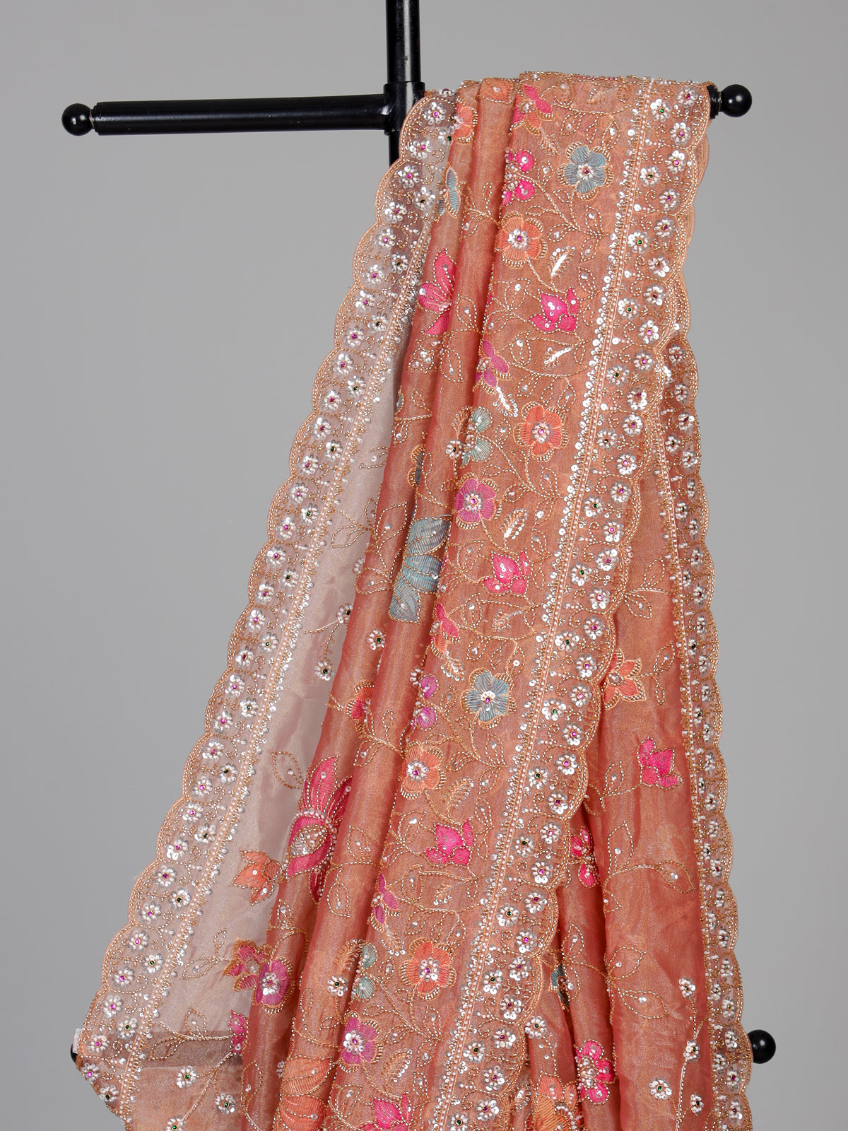 Pastel peach tissue silk saree with floral cutdana and tassels